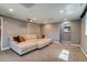 Spacious carpeted basement, ideal for entertaining, featuring a large sectional sofa at 16978 W 87Th Ave, Arvada, CO 80007