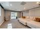 Entertainer's basement with large sofa and sliding glass doors to the backyard at 16978 W 87Th Ave, Arvada, CO 80007