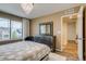 Bedroom with a dresser, area rug, and a view of the neighborhood from the bright window at 16978 W 87Th Ave, Arvada, CO 80007