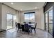 Bright dining area featuring large windows, a modern table, and comfortable seating for enjoying meals with scenic views at 16978 W 87Th Ave, Arvada, CO 80007