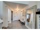 Inviting entryway featuring modern flooring, an oversized mirror, and stylish decor with light colors at 16978 W 87Th Ave, Arvada, CO 80007