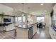 Spacious kitchen island provides seating and extra counter space, with views to the living and dining areas at 16978 W 87Th Ave, Arvada, CO 80007