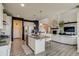 Open-concept kitchen features a large island, stainless steel appliances, and views to the living room and staircase at 16978 W 87Th Ave, Arvada, CO 80007