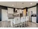 Stylish kitchen with stainless steel appliances, granite countertops, and ample cabinet space with black accent wall at 16978 W 87Th Ave, Arvada, CO 80007