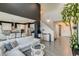Inviting living room featuring an open concept design, sleek flooring, and high ceilings with dark accents at 16978 W 87Th Ave, Arvada, CO 80007