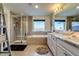 Luxurious main bathroom with a soaking tub, a separate glass-enclosed shower, and a double vanity at 16978 W 87Th Ave, Arvada, CO 80007