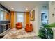 Sitting room showcasing two orange swivel chairs, decorative accents, and an inviting atmosphere at 16978 W 87Th Ave, Arvada, CO 80007