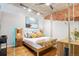 Stylish bedroom with modern lighting, hardwood floors, and exposed ductwork at 1720 Wazee St # 2B, Denver, CO 80202
