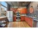 Modern kitchen features stainless steel appliances, wood cabinets, and hardwood floors at 1720 Wazee St # 2B, Denver, CO 80202