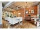 Comfortable living room featuring exposed duct work, brick wall, and wood floors at 1720 Wazee St # 2B, Denver, CO 80202