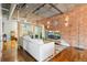 Elegant living room boasts hardwood floors, exposed ductwork, and a partial view of the bedroom at 1720 Wazee St # 2B, Denver, CO 80202