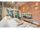 Stylish living room with exposed brick wall, wood floors, modern lighting, and a comfortable sectional at 1720 Wazee St # 2B, Denver, CO 80202