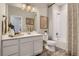 Bright bathroom with single sink vanity, shower over tub, and modern decor at 6807 Huddersfield Ln, Castle Pines, CO 80108