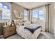 Cozy bedroom with neutral tones features a large window and accent decor at 6807 Huddersfield Ln, Castle Pines, CO 80108
