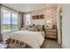 Bright bedroom with neutral tones features a large window and decorative pillows at 6807 Huddersfield Ln, Castle Pines, CO 80108