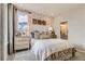 Bedroom with neutral decor with big window offering lots of natural light at 6807 Huddersfield Ln, Castle Pines, CO 80108