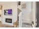 Entryway with tiled accent wall, modern fireplace, stairs and grey carpet floors at 6807 Huddersfield Ln, Castle Pines, CO 80108