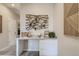 Hall desk in neutral tones features natural art and bright space at 6807 Huddersfield Ln, Castle Pines, CO 80108