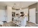 Well-lit kitchen with a granite island, pendant lighting, stainless steel appliances, and wood floor at 6807 Huddersfield Ln, Castle Pines, CO 80108