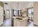 Open-concept kitchen with island, stainless steel appliances and view into living area at 6807 Huddersfield Ln, Castle Pines, CO 80108