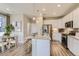 Bright kitchen with island seating, stainless steel appliances, and modern finishes at 6807 Huddersfield Ln, Castle Pines, CO 80108