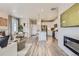 An open-concept living space includes a modern kitchen and a cozy fireplace with a large TV at 6807 Huddersfield Ln, Castle Pines, CO 80108