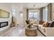 View of a stylish living room featuring neutral decor and a modern fireplace at 6807 Huddersfield Ln, Castle Pines, CO 80108