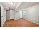 Basement room featuring laminate floors, multiple doors, and a window at 1646 S Stuart St, Denver, CO 80219