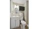 Bathroom with a white toilet, sink, and vanity with modern fixtures at 1646 S Stuart St, Denver, CO 80219