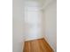 A closet with light walls, hooks, a shelf, and hardwood floors at 1646 S Stuart St, Denver, CO 80219
