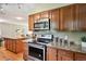 Bright kitchen with stainless steel appliances, a breakfast bar and overlooks into the living room at 1646 S Stuart St, Denver, CO 80219