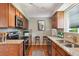 Well-appointed kitchen features granite countertops, stainless appliances, and hardwood flooring at 1646 S Stuart St, Denver, CO 80219