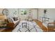 Comfortable living room with a warm brown couch, stylish rug, and front door view at 1646 S Stuart St, Denver, CO 80219