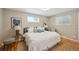 Cozy primary bedroom with natural light, neutral walls, hardwood floors and decorative accents at 1646 S Stuart St, Denver, CO 80219