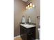 Bathroom with a brown cabinet vanity, a large mirror and a decorative tile backsplash at 14022 E Fair Pl, Centennial, CO 80111