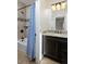 Bathroom featuring a shower-tub combo with blue shower curtain, granite vanity and a well-lit mirror at 14022 E Fair Pl, Centennial, CO 80111