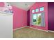 Colorful bedroom with a vaulted ceiling, purple accent wall, and soft carpet at 14022 E Fair Pl, Centennial, CO 80111