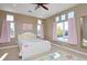 Bedroom with large windows, pink curtains, and a white bed frame at 14022 E Fair Pl, Centennial, CO 80111