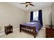 Bright bedroom with a wooden bed frame, blue curtains, and carpet flooring at 14022 E Fair Pl, Centennial, CO 80111