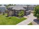 Beautiful exterior elevation of a brown two-story home with landscaped front yard and driveway at 14022 E Fair Pl, Centennial, CO 80111