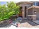 Inviting front entry with stone columns and colorful potted flowers lining the walkway at 14022 E Fair Pl, Centennial, CO 80111