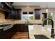 Gourmet kitchen with stainless steel appliances, granite countertops, dark wood cabinets, and hardwood floors at 14022 E Fair Pl, Centennial, CO 80111
