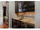A charming kitchen pantry area featuring elegant display cabinets and a wine cooler at 14022 E Fair Pl, Centennial, CO 80111