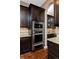 Modern kitchen boasts stainless steel appliances and stylish dark wood cabinets at 14022 E Fair Pl, Centennial, CO 80111