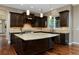Gourmet kitchen boasts dark wood cabinets, granite countertops, and a large center island at 14022 E Fair Pl, Centennial, CO 80111