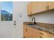 Laundry room features light wood cabinets and a door to the outside at 14022 E Fair Pl, Centennial, CO 80111