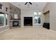 Open living room with a cozy stone fireplace, perfect for entertaining at 14022 E Fair Pl, Centennial, CO 80111