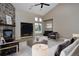Staged living room boasts vaulted ceilings and a stone fireplace at 14022 E Fair Pl, Centennial, CO 80111