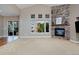 Bright living room features a cozy fireplace and large windows at 14022 E Fair Pl, Centennial, CO 80111