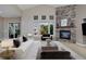 Staged bright living room features a fireplace and large windows at 14022 E Fair Pl, Centennial, CO 80111